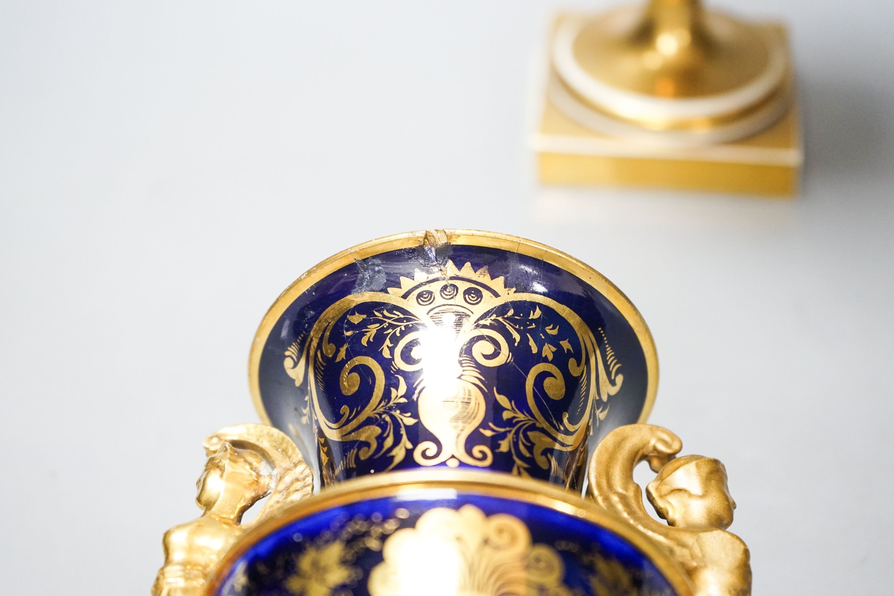 A garniture of three early 19th century English porcelain vases, c.1815-20, each painted with topographical views, tallest 26cm